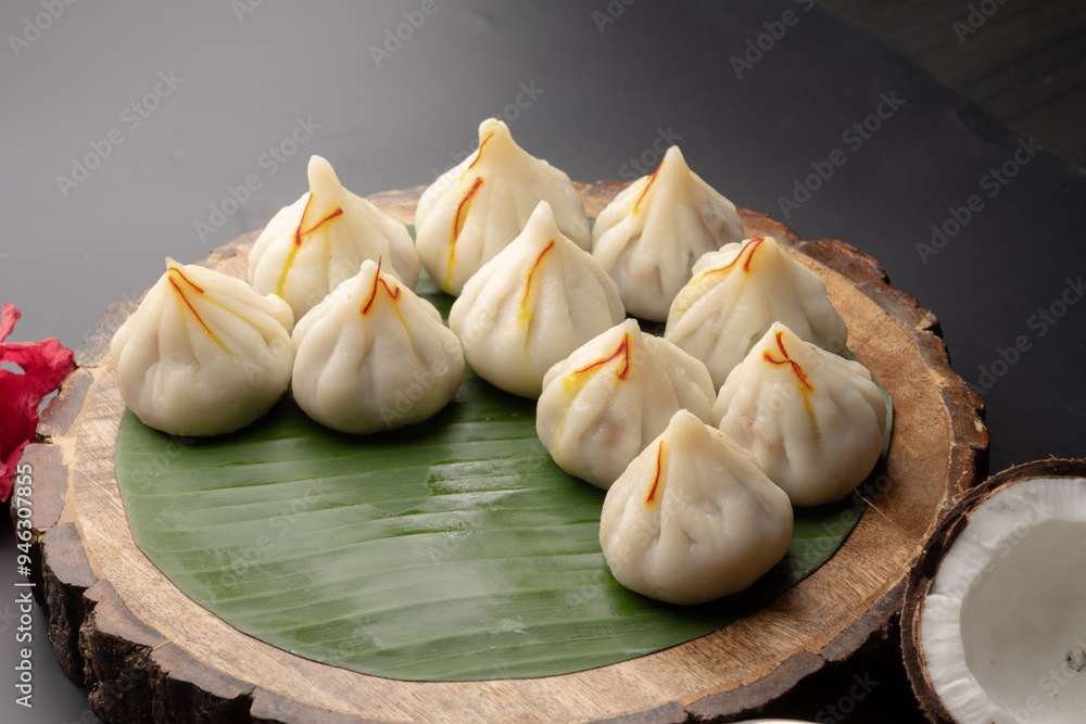 Steamed Modak, white modak, ukdiche modak made from rice flour and coconut jaggery filling. Modak is a traditional Indian sweet made during Ganesh Utsav Steamed Modak, white modak, ukdiche modak made from rice flour and coconut jaggery filling. Modak is a traditional Indian sweet made during Ganesh Utsav
