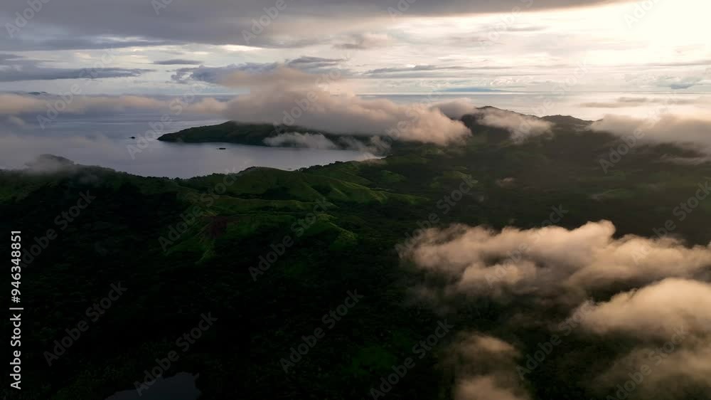 Aerial view of serene jungle and majestic mountains with a tranquil lake at sunrise, Fiji. Aerial view of serene jungle and majestic mountains with a tranquil lake at sunrise, Fiji.