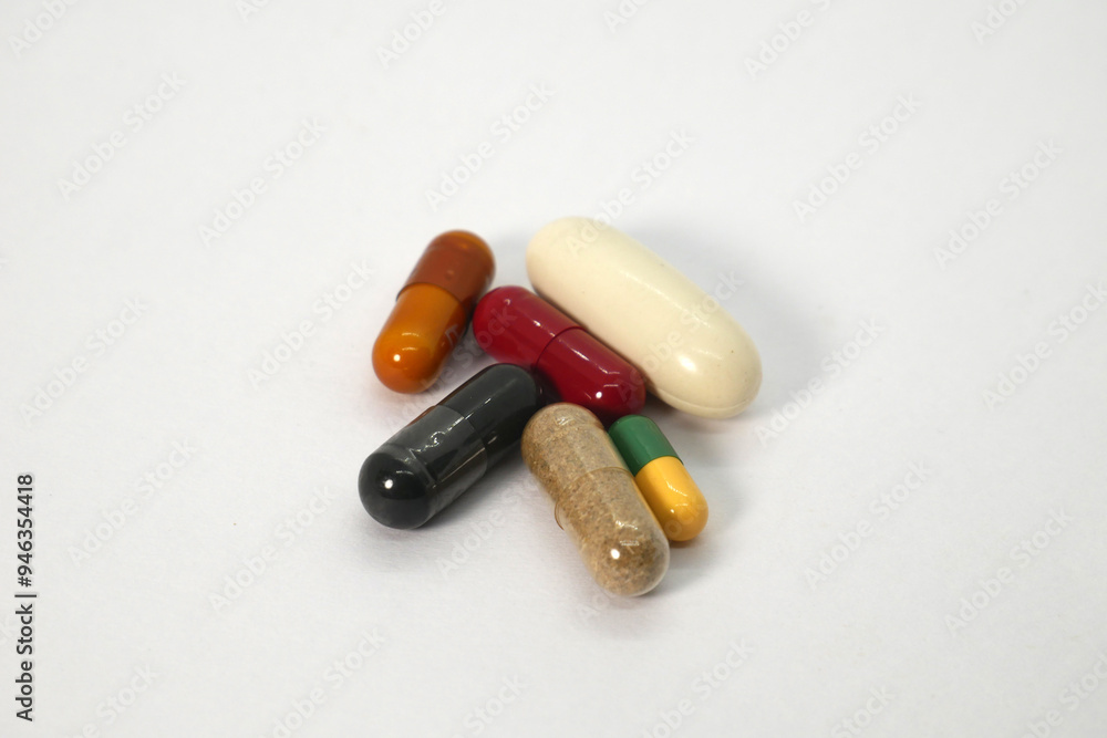 close up of multiple colorful medicine capsules on the white background isolated close up of multiple colorful medicine capsules on the white background isolated