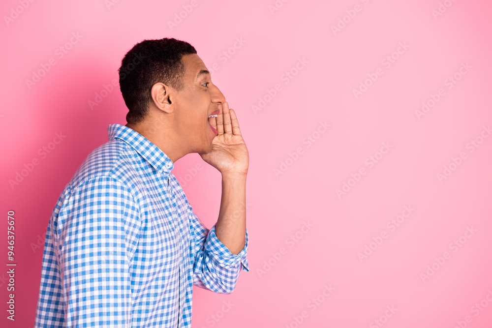 Photo of cheerful positive guy dressed checkered shirt arm mouth screaming emtpy space isolated pink color background Photo of cheerful positive guy dressed checkered shirt arm mouth screaming emtpy space isolated pink color background