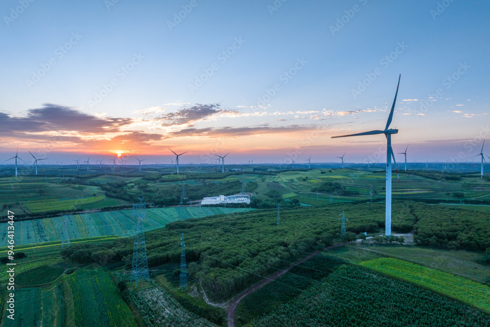 view of wind power turbine in field at sunset view of wind power turbine in field at sunset