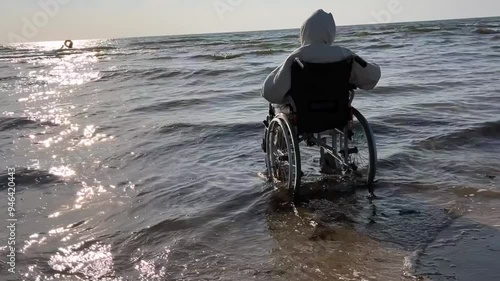 Inclusive Beach Experience: Person in Wheelchair Enjoying the Sea