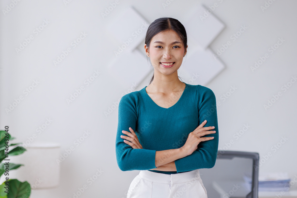 Portrait of young Asain business woman standing with confidence expression arms crossed and looking at the camera in the office. Portrait of young Asain business woman standing with confidence expression arms crossed and looking at the camera in the office.