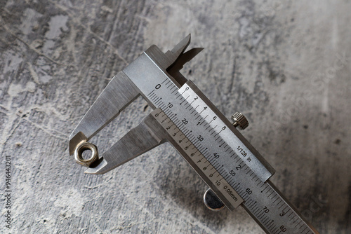 Papier peint Measuring the size of a nut using a vernier caliper
