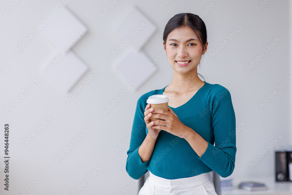 Young successful employee business asian woman in blue shirt work hold takeaway delivery craft paper cup coffee to go stand at desk with laptop pc computer at office. Young successful employee business asian woman in blue shirt work hold takeaway delivery craft paper cup coffee to go stand at desk with laptop pc computer at office.