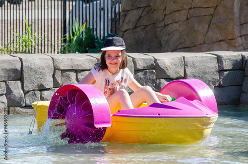Принти на полотні Kid playing rowing water paddle boat. Soft focus.