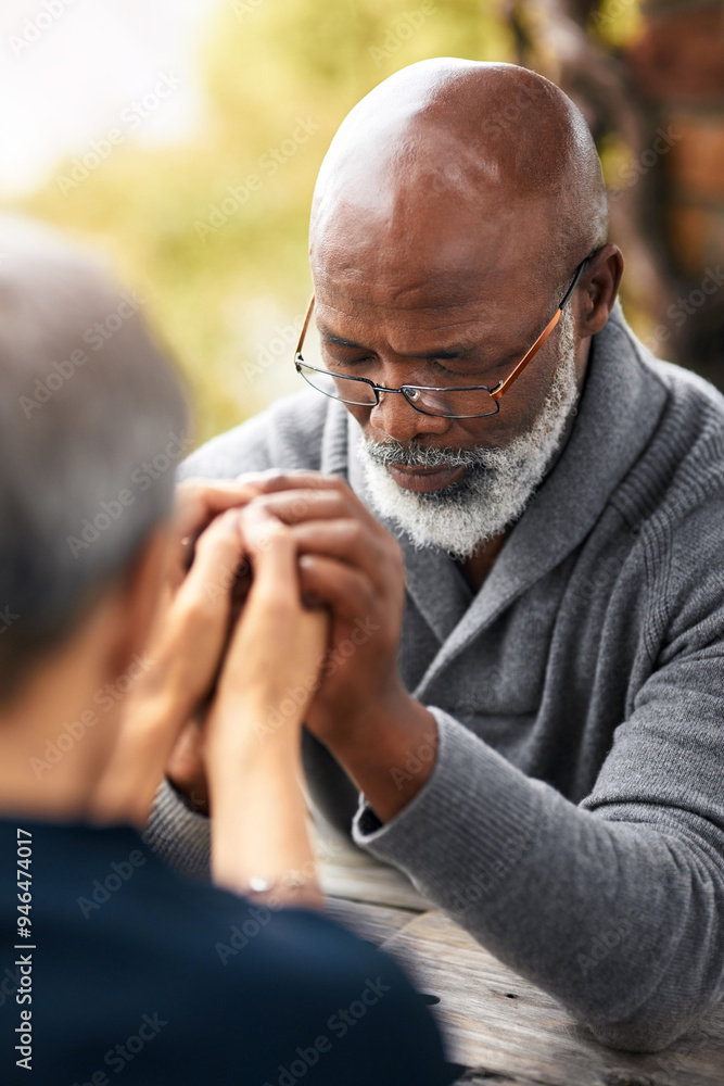 Fototapeta premium Holding hands, couple and faith of people, table and religion of mature man, glasses and respect. Outdoor, Christian and worship of God in park, praying and praise of holy spirit, together and grace