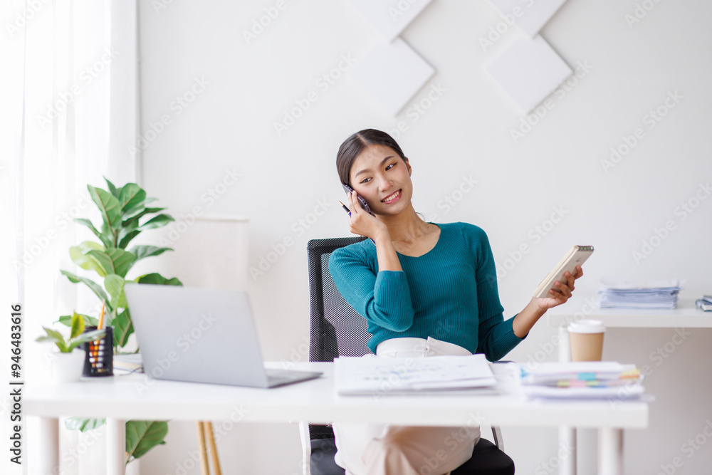 Cheerful business Asian woman freelancer making telephone call share good news about project working in office workplace, business finance concept.
Cheerful business Asian woman freelancer making telephone call share good news about project working in office workplace, business finance concept.