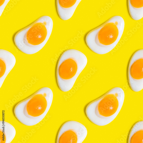 Seamless pattern with gummy fried egg on yellow background. photo