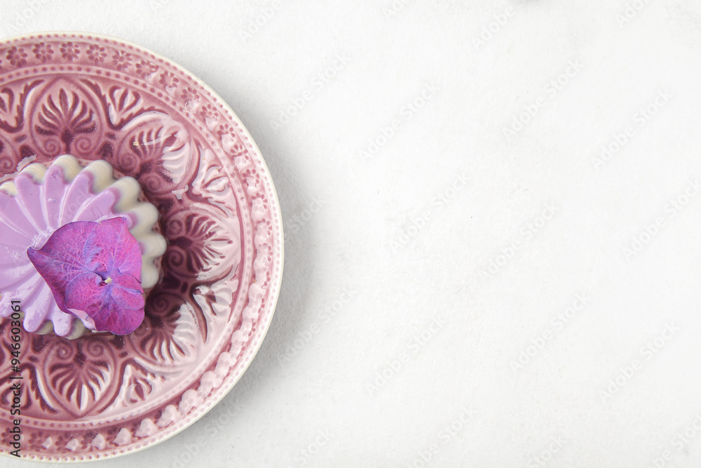 Plate of panna cotta with beautiful hydrangea flower on white table Plate of panna cotta with beautiful hydrangea flower on white table