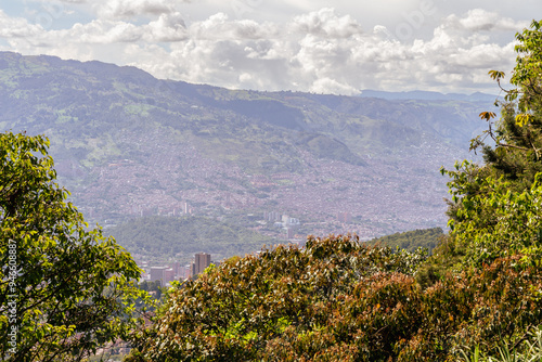 Creative panorama (cityscape) of Medellin, Medellín, Antioquia, Colombia, on a sunny day. The pictures shows condominiums. Green trees in the foreground.