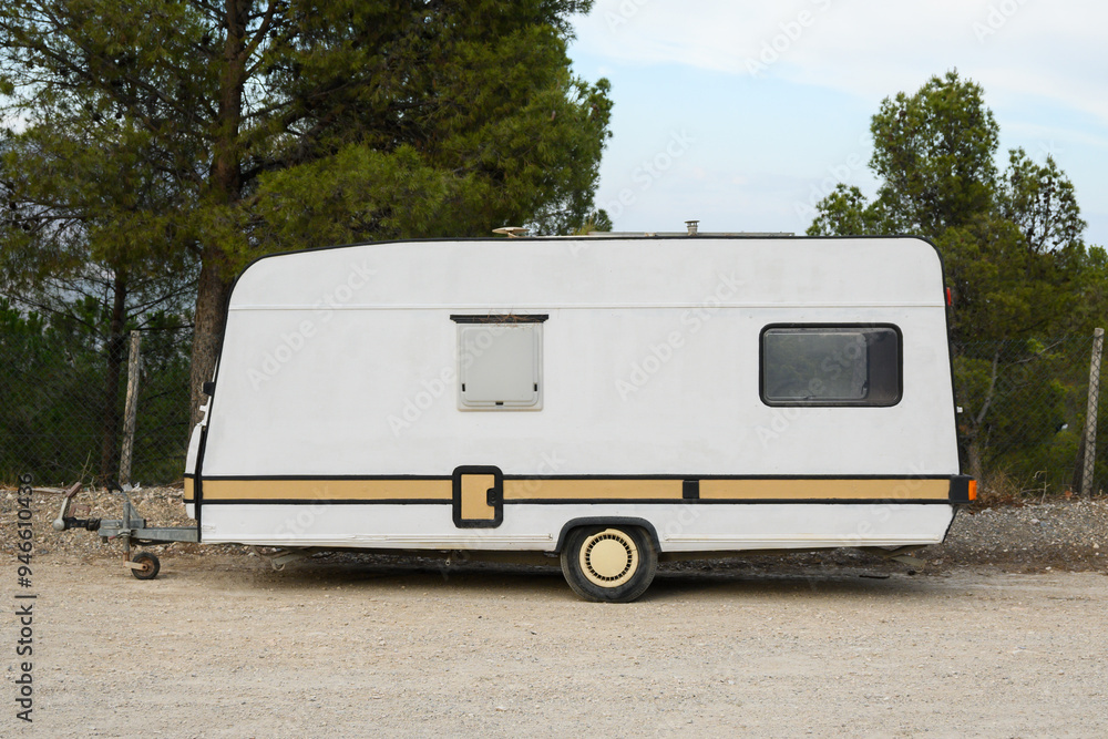 Trailer of mobile home stands in garden in camping Trailer of mobile home stands in garden in camping