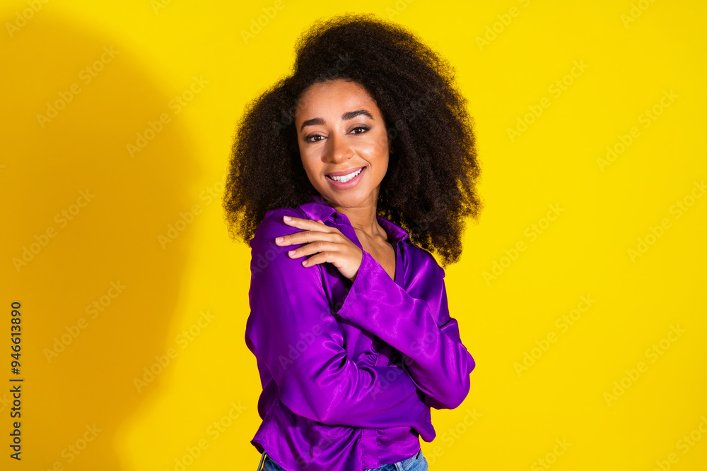 Photo portrait of pretty young girl hugging self wear trendy violet outfit isolated on yellow color background Photo portrait of pretty young girl hugging self wear trendy violet outfit isolated on yellow color background