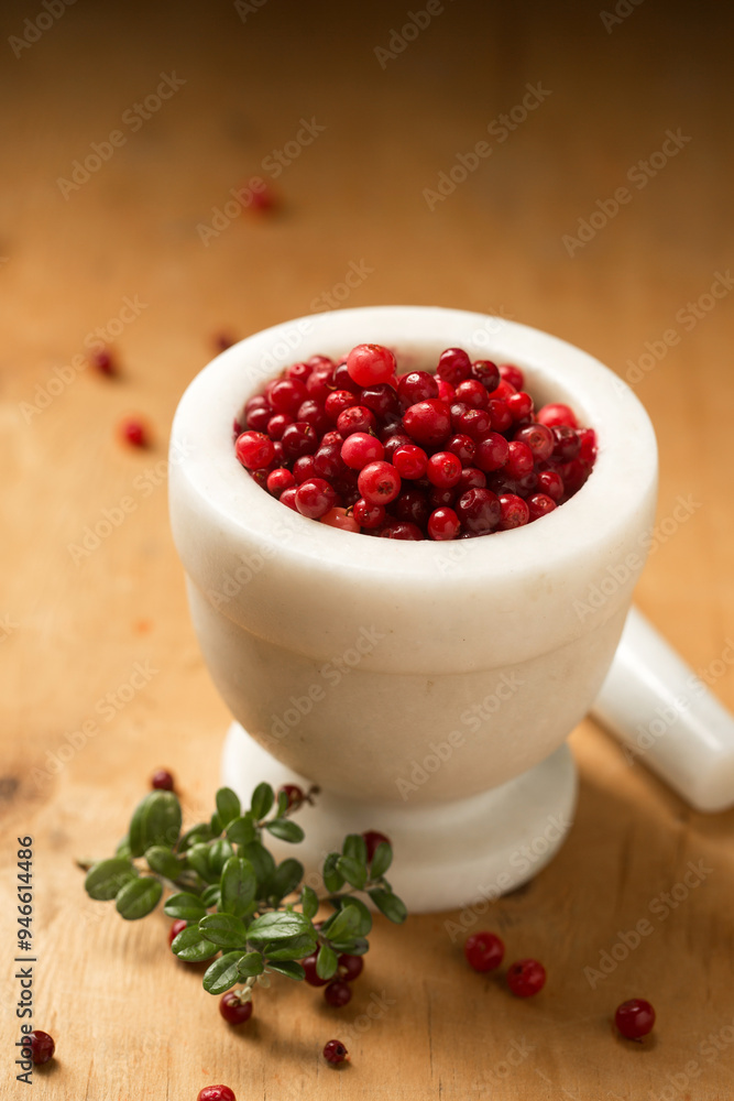 A mortar full of ripe wild lingonberries A mortar full of ripe wild lingonberries