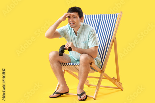 Young man with binoculars s...