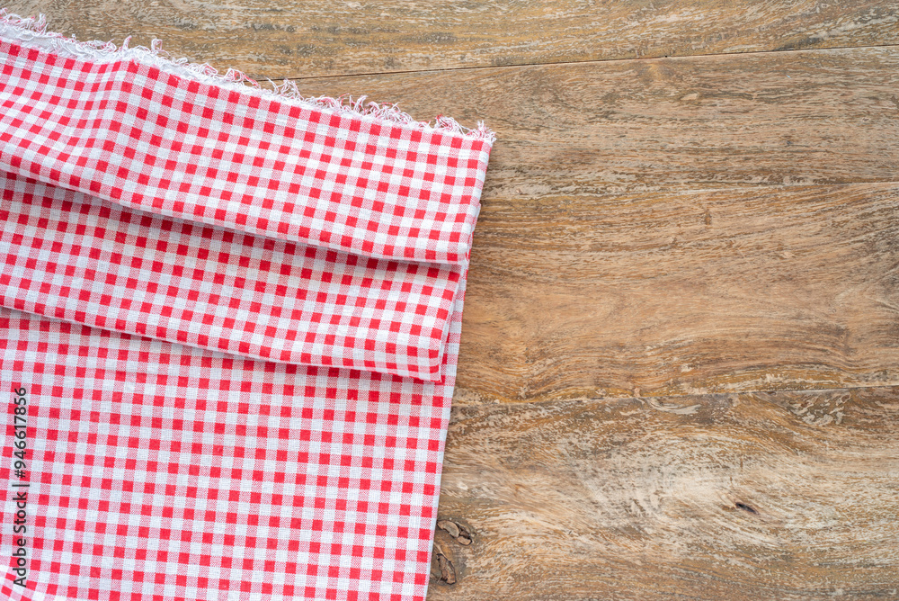 Obraz premium Part of tablecloth over wooden surface.