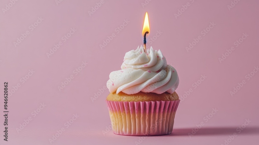 Creamy cupcake with a burning candle isolated on pink background with copy space. Sweet dessert for birthday party Creamy cupcake with a burning candle isolated on pink background with copy space. Sweet dessert for birthday party