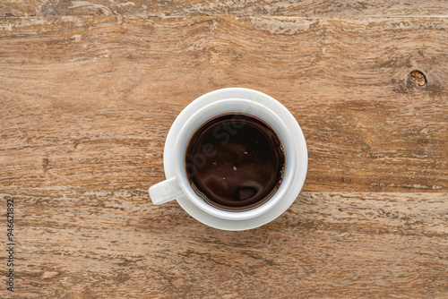 Cup of black coffee on wooden background.