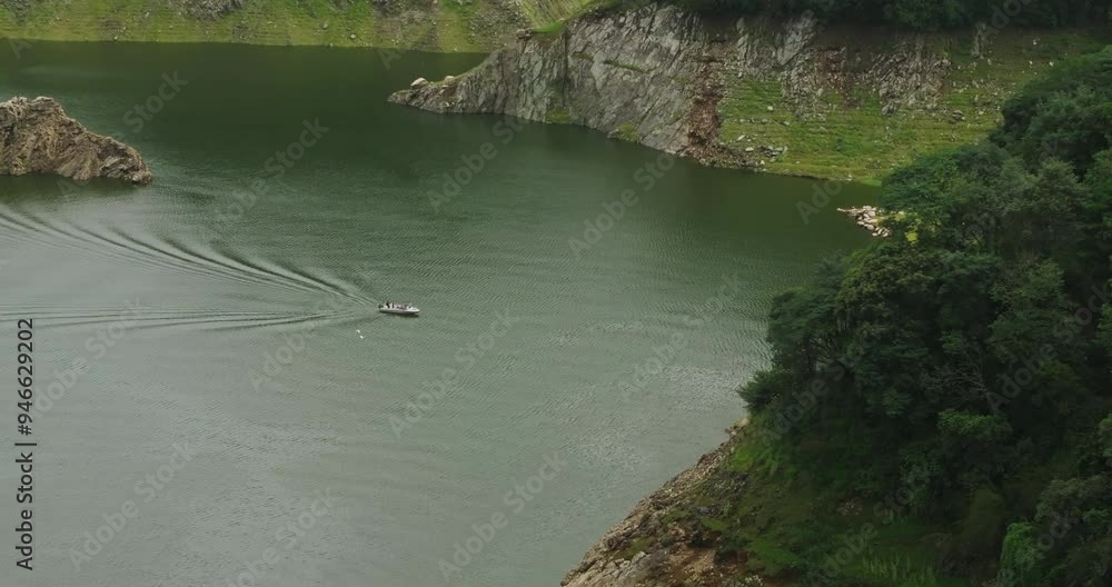 Drone shot of a water boat cruising through a tranquil lake in Nepal scene captures the serene landscape and untouched beauty, making it a famous and unreal visual experience in Nepali water tourism. Drone shot of a water boat cruising through a tranquil lake in Nepal scene captures the serene landscape and untouched beauty, making it a famous and unreal visual experience in Nepali water tourism.