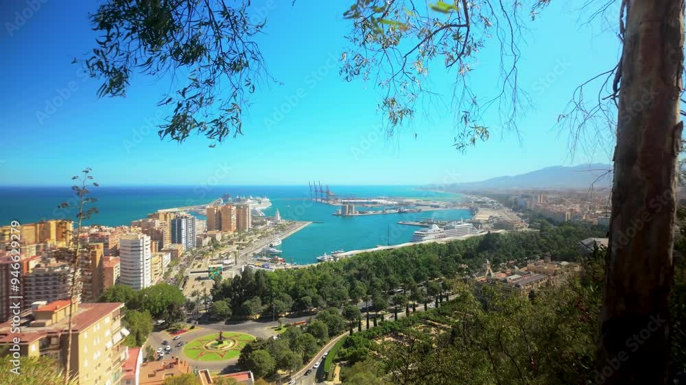 A picturesque aerial shot of Malaga, Spain, highlighting the city's lush greenery, urban landscape, and the vibrant port area extending into the deep blue sea A picturesque aerial shot of Malaga, Spain, highlighting the city's lush greenery, urban landscape, and the vibrant port area extending into the deep blue sea