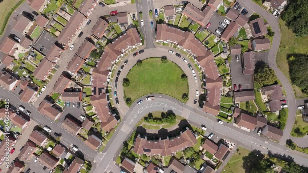 Drone fly-in view of new build residential flats arranged in a circular pattern, capturing the symmetry and modern design of the housing estate in Exeter, England Drone fly-in view of new build residential flats arranged in a circular pattern, capturing the symmetry and modern design of the housing estate in Exeter, England
