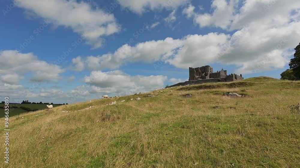 Ireland Epic locations dramatic sky over The rock of Cashel with sheep grazing at the foot of the historic site in summer Ireland Epic locations dramatic sky over The rock of Cashel with sheep grazing at the foot of the historic site in summer