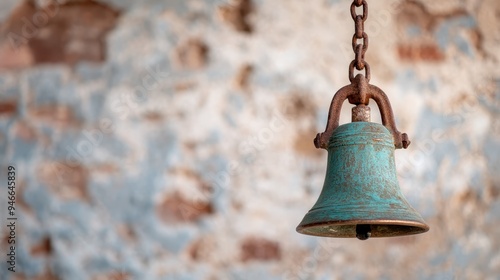 An antique bell in a distressed, blue-painted brick background, showcasing charm and timeless appeal, blending rustic aesthetics with historical significance. photo