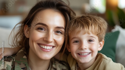 A military mother, shown in uniform, smiles proudly with her young son in a warm and comfortable setting, symbolizing strength, pride, and familial love.