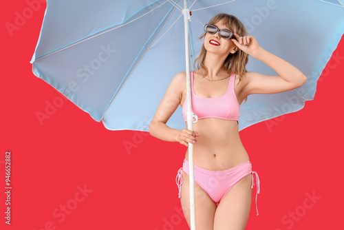 Young woman with beach umbr...