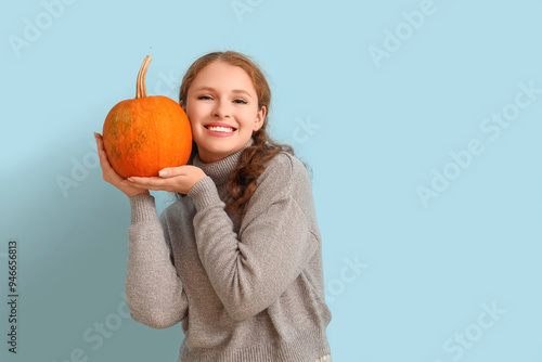 Young woman with pumpkin on...
