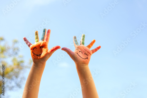 Children's painted hands with smiling faces. Happiness, joy, education, creative, school concept
