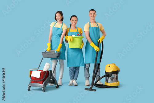 Young janitors with cleanin...