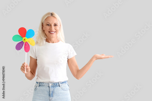 Mature woman with toy windm...