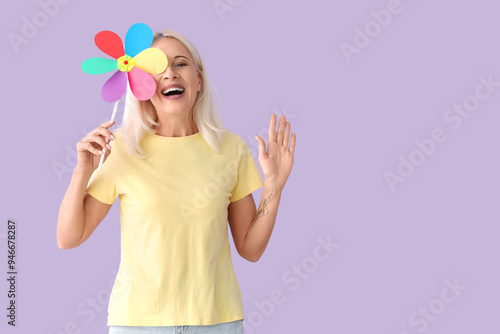 Mature woman with toy windm...