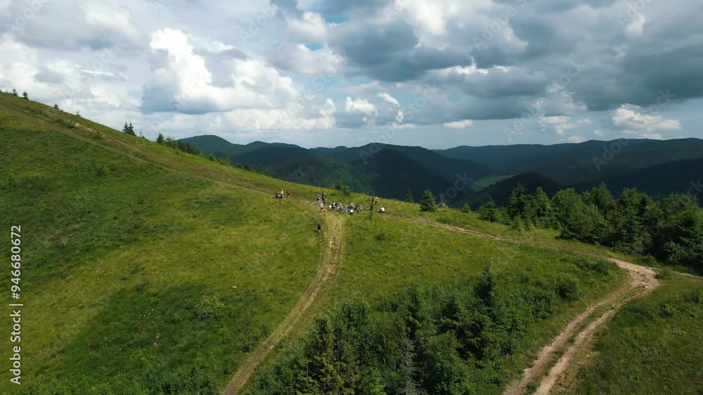 Drone flight over mountainous terrain, beautiful landscape. Beautiful mountain scenery, tourists stopped to rest on a mountain path against the background of a fantastic mountain landscape. Tourists Drone flight over mountainous terrain, beautiful landscape. Beautiful mountain scenery, tourists stopped to rest on a mountain path against the background of a fantastic mountain landscape. Tourists