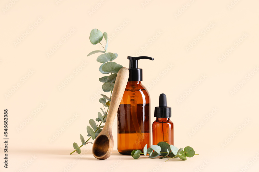 Wooden spoon and bottles of eucalyptus essential oil on beige background Wooden spoon and bottles of eucalyptus essential oil on beige background