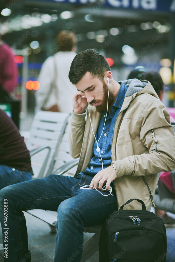 Travel, earphones and man with phone at airport for music, streaming subscription and radio. International trip, commute and person waiting on smartphone for listening to song, audio and podcast Travel, earphones and man with phone at airport for music, streaming subscription and radio. International trip, commute and person waiting on smartphone for listening to song, audio and podcast