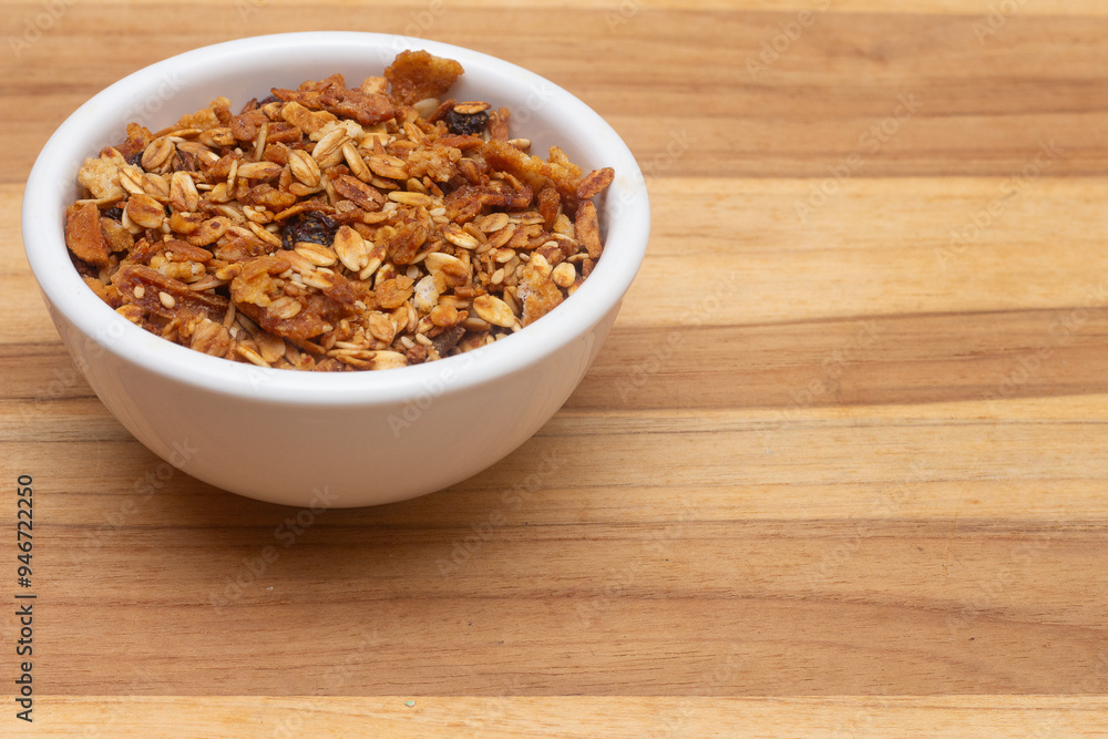 white bowl full of granola. white bowl full of granola.