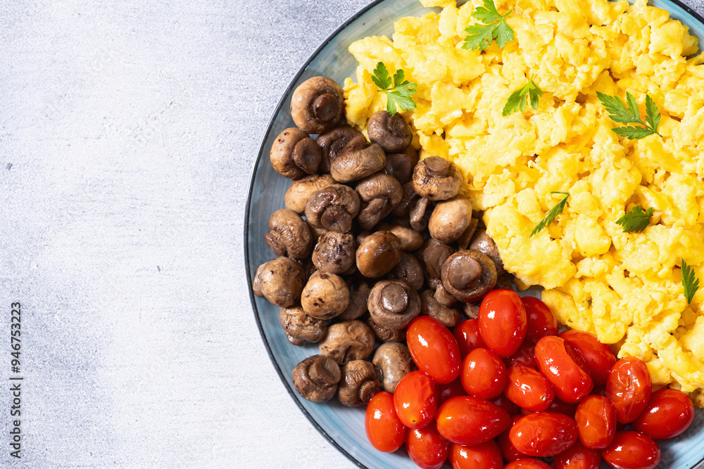 Homemade scrambled eggs with mushrooms and cherry tomatoes Homemade scrambled eggs with mushrooms and cherry tomatoes