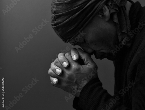 man praying to god with hands together Caribbean man praying on black background with people stock photos stock photo stock image 