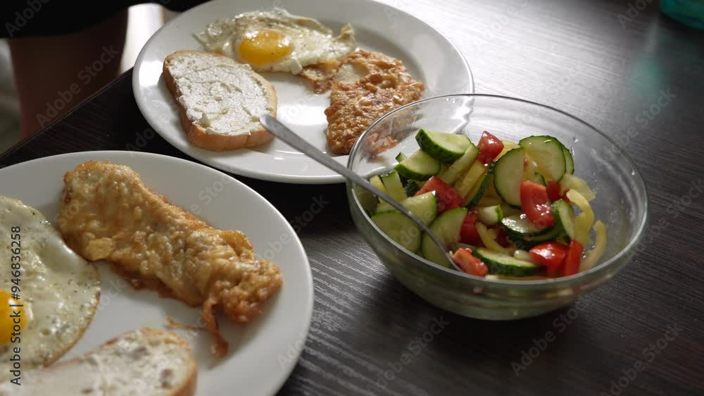 Breakfast fried eggs with salad and toast. Two servings Breakfast fried eggs with salad and toast. Two servings