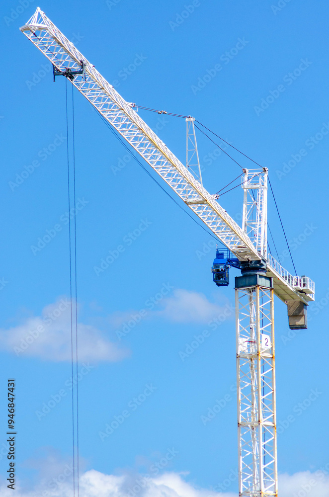 Close-Up of Construction Crane Against Clear Blue Sky on a Sunny Day Close-Up of Construction Crane Against Clear Blue Sky on a Sunny Day