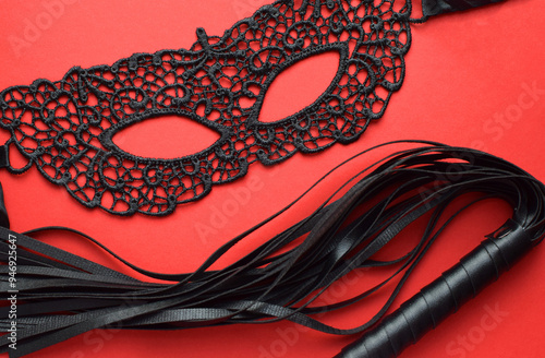 Erotic black lace mask and leather whip for sex games. BDSM toys for role-playing sex games.