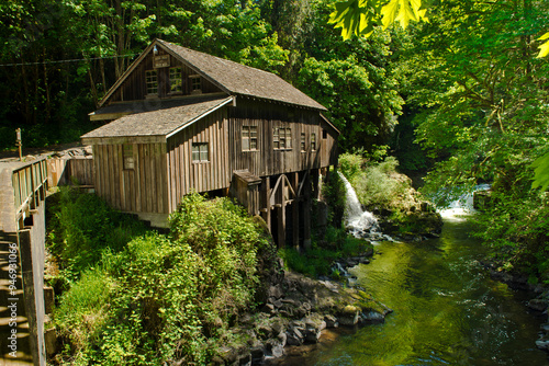 Mill house in Washington state next to river photo