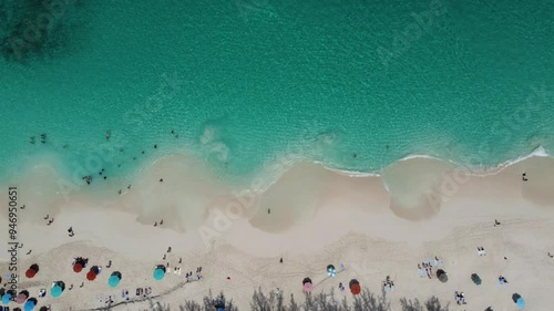 4К People chilling in transparent blue sea in Bahamas. Aerial view, top view.