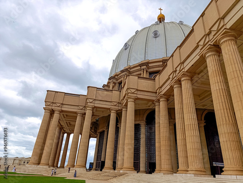 Huge stone pillars at the entrance to the Basilica of Our Lady of Peace in Yamoussoukro under a blue sky, Ivory Coast 01