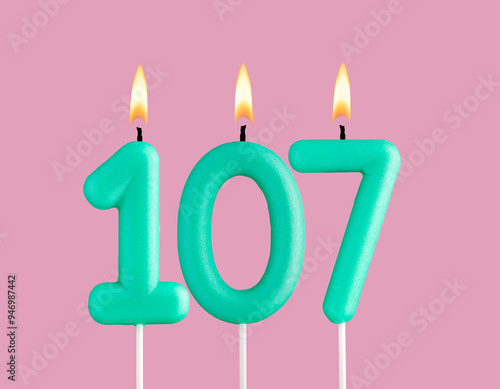 Green candle number 107 - Birthday card on pastel pink background