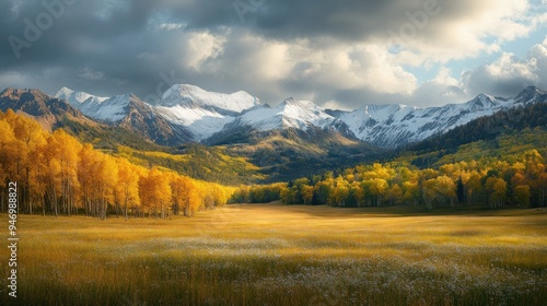 Golden Aspens and Snow-Capped Mountains in a Dramatic Landscape