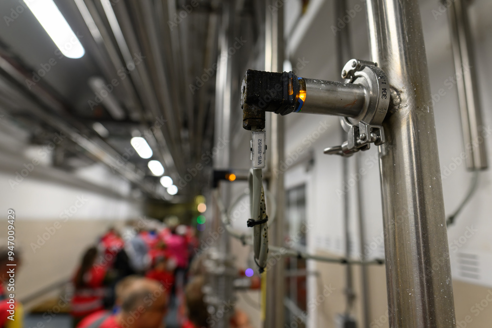 Electronic sensor on a stainless steel pipe.
Electronic sensor on a stainless steel pipe.