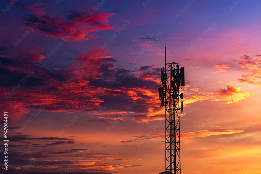 Telecommunication towers with colorful sky as a backdrop in the morning and sunlight reflecting off clouds create a stunning and mesmerizing light effect. Concept of innovation, technology and environ Telecommunication towers with colorful sky as a backdrop in the morning and sunlight reflecting off clouds create a stunning and mesmerizing light effect. Concept of innovation, technology and environ